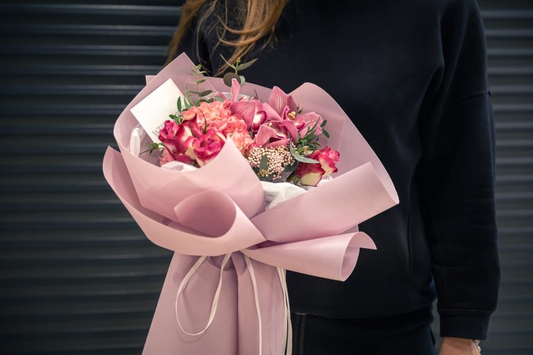 Close-up of a bouquet of pink flowers in female hands.Close-up of a bouquet of pink flowers in female hands.